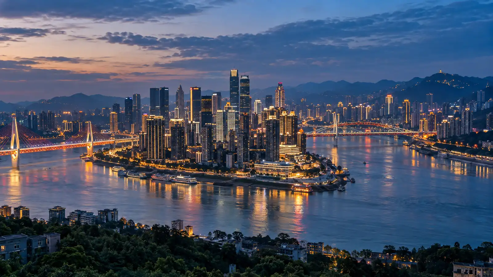 Chongqing rivers and vertical skyline Chongqing skyline rising above the Yangtze and Jialing rivers at blue hour