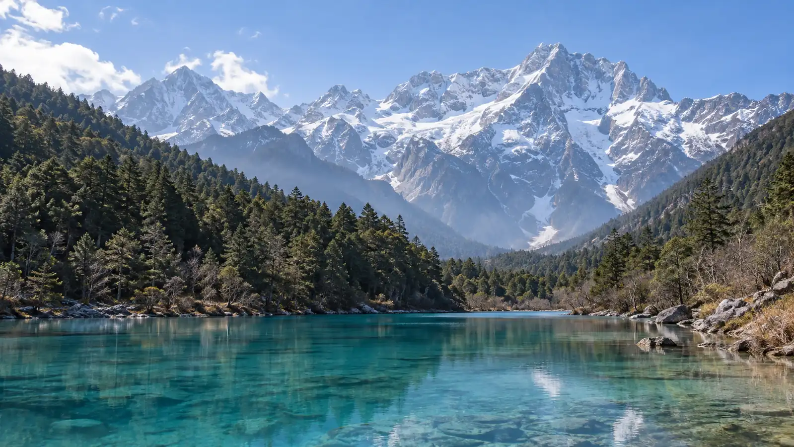 Jade Dragon Snow Mountain above a turquoise alpine lake Jade Dragon Snow Mountain above a turquoise alpine lake