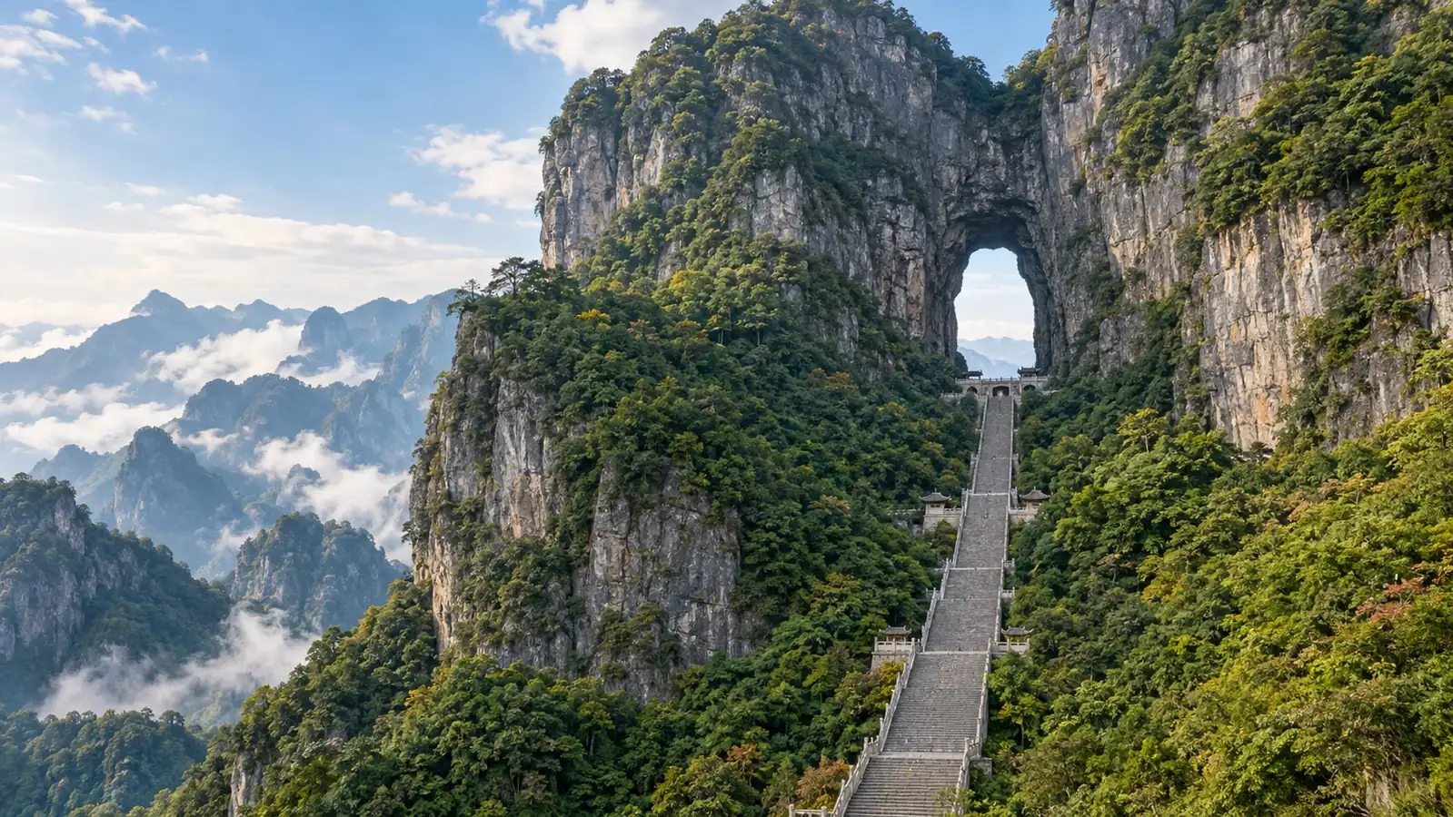 Tianmen Cave and stone stairway in forested mountains Tianmen Cave and stone stairway in forested mountains