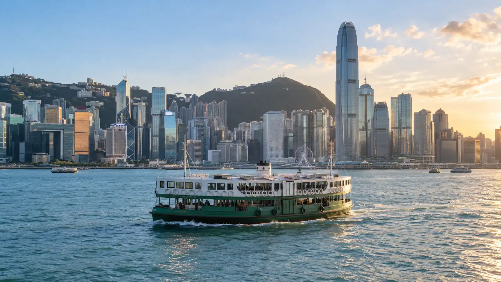 Star Ferry crossing Victoria Harbour beside the Hong Kong skyline Star Ferry crossing Victoria Harbour beside the Hong Kong skyline