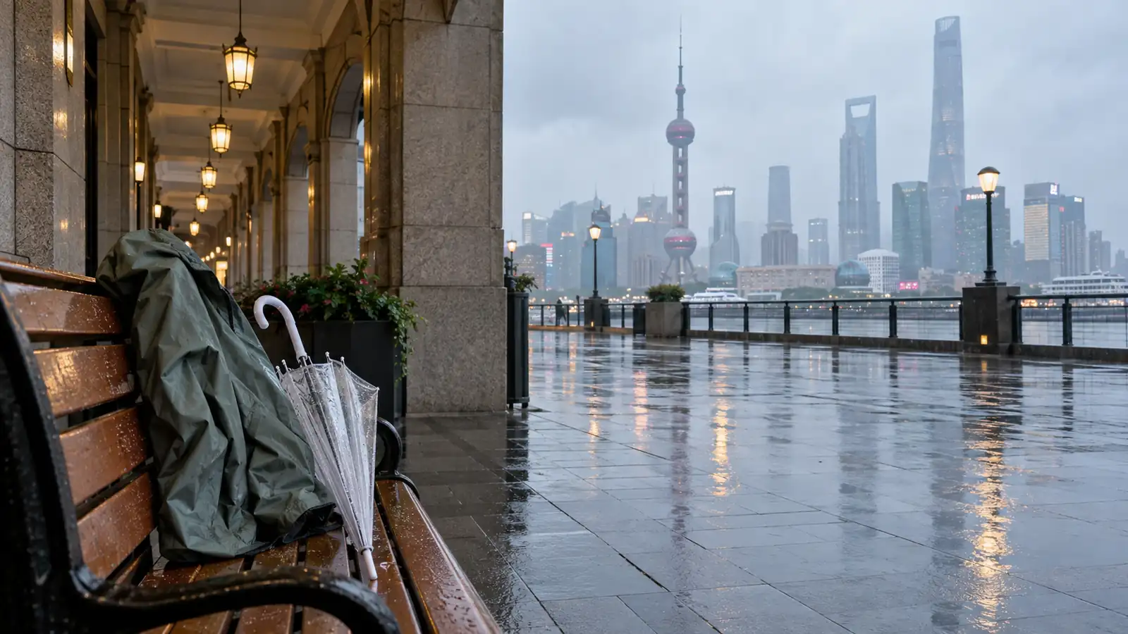 Rain jacket and umbrella beside a wet Shanghai waterfront Rain jacket and umbrella beside a wet Shanghai waterfront