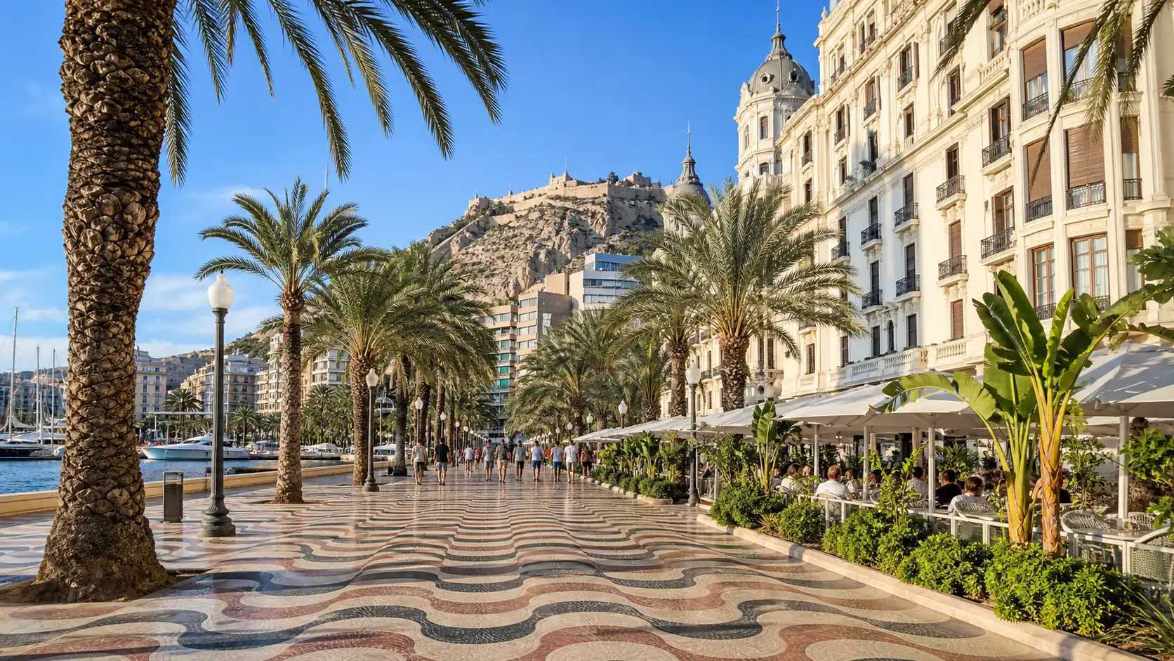 Alicante Explanada promenade with palm trees and castle in the background