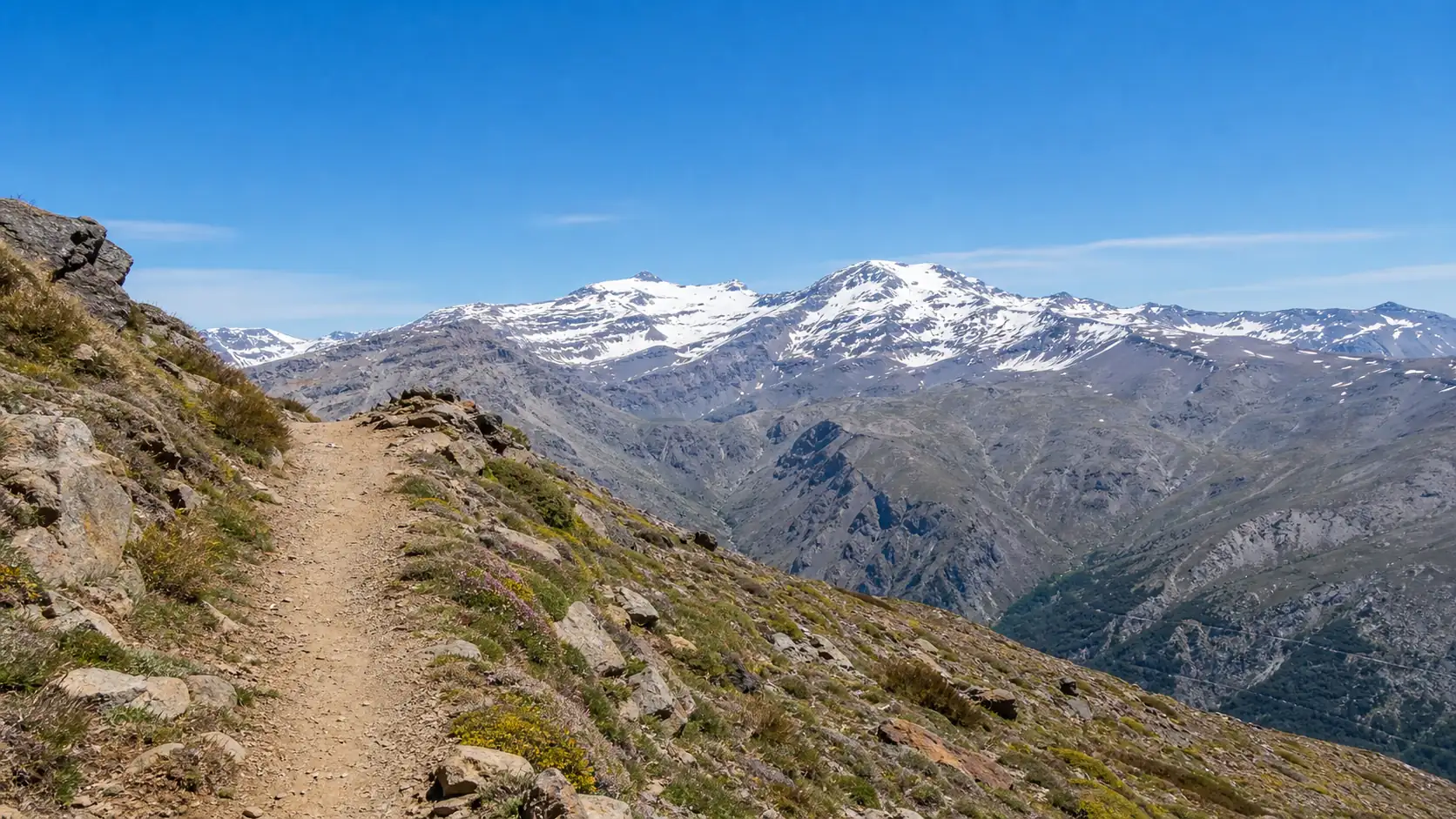 Sierra Nevada hiking path near Granada with snowy mountain views Sierra Nevada hiking path near Granada with snowy mountain views