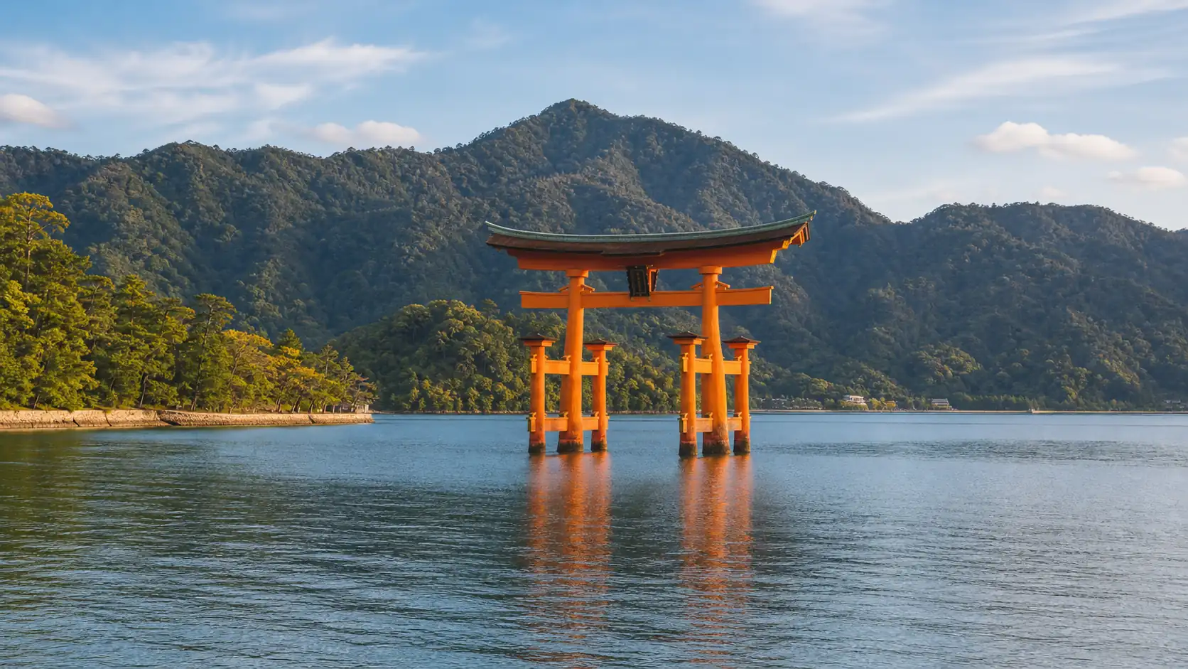 Miyajima floating torii gate with calm inland sea and forested hills Miyajima floating torii gate with calm inland sea and forested hills