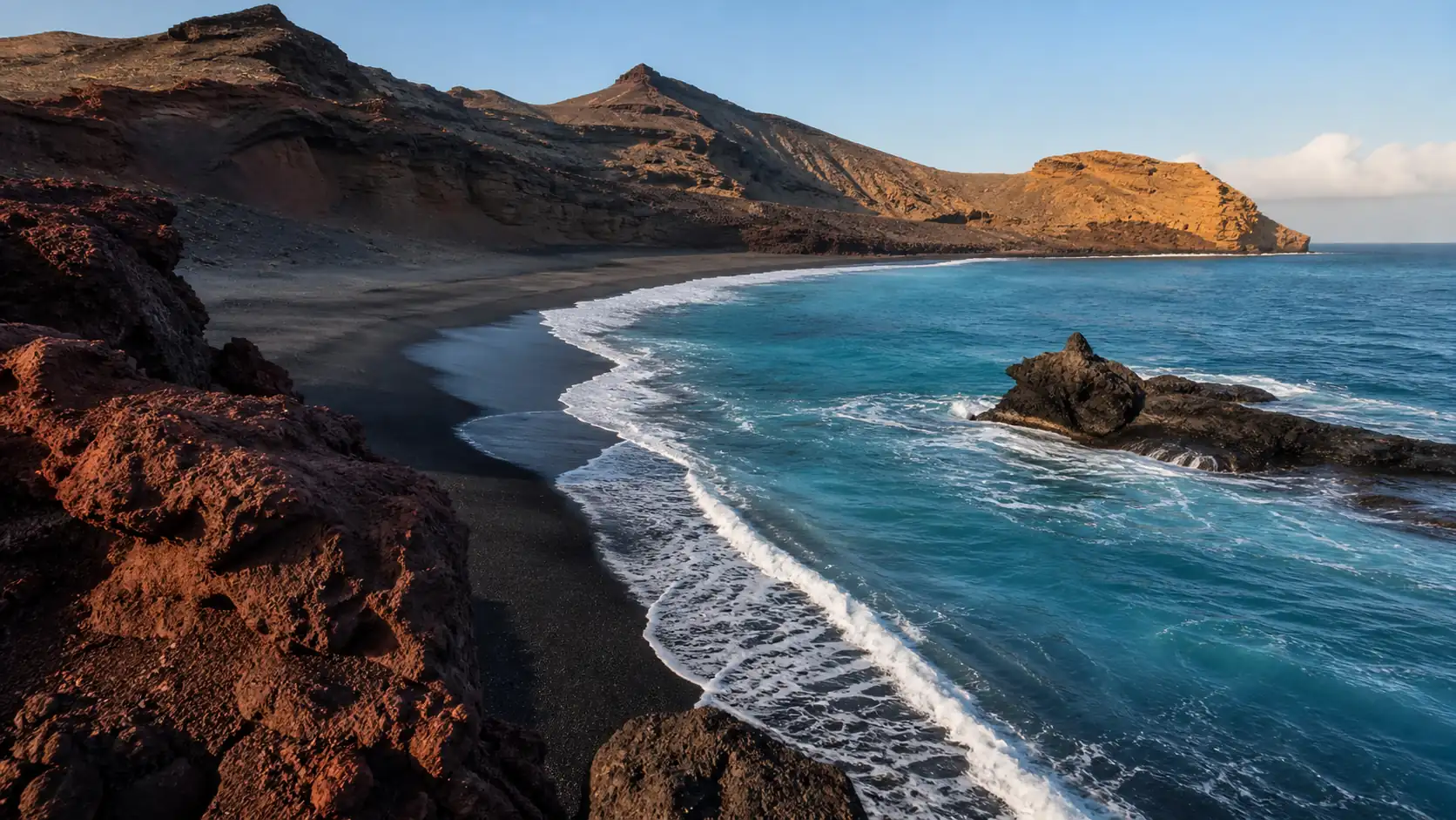 Black volcanic beach and turquoise water in the Canary Islands Black volcanic beach and turquoise water in the Canary Islands